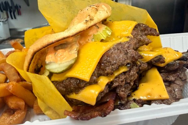 Double smash burger with bacon and fries; extras are priced separately.